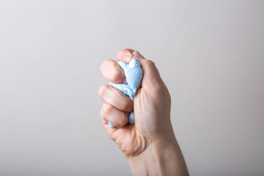 a person holding something in their left hand