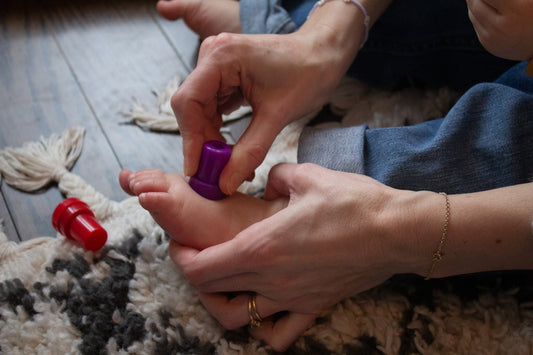 a woman is sitting on the floor with a pair of scissors