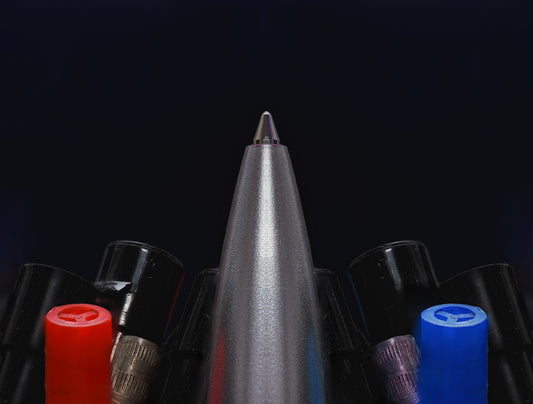 A group of different colored pens sitting next to each other