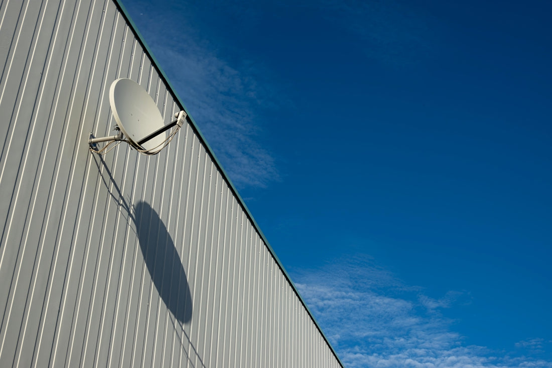 A satellite dish on the side of a building