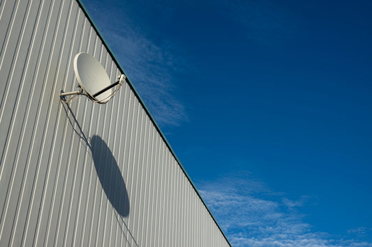 A satellite dish on the side of a building